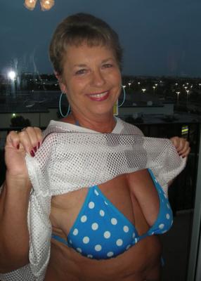 Big tit granny showing her bikini on holiday.