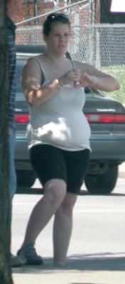 Street Girl with serious spare tire belly overhang, tight T Shir
