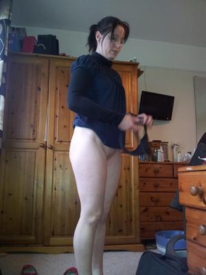 Bottomless raven haired babe showing off her ass 
