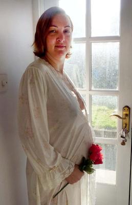Pregnant wife in see through gown