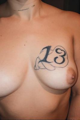Gotta tattooed tit say number 