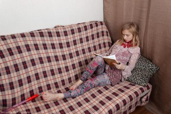 Masturbating on a sofa with a dildo